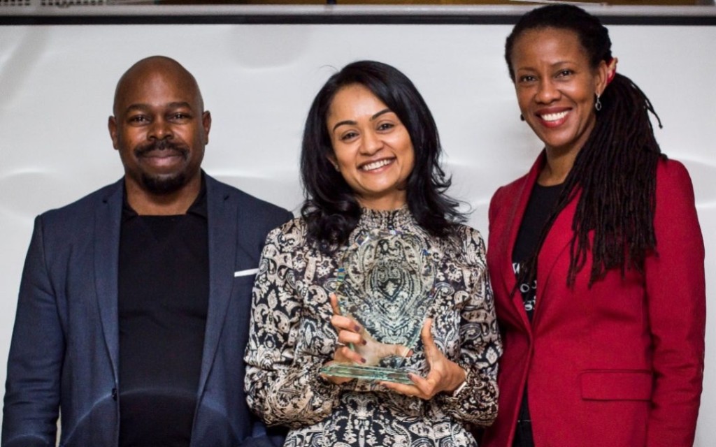 President Dr. Phaedria Marie St.Hilaire and Advisory board member Ade Adeluwoye presenting the first ProWoc Impact award to Dr. Poornima Luthra.